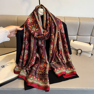 Colorful patterned scarf on a mannequin against a neutral background