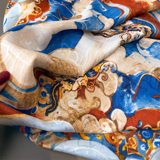 Close-up of a patterned fabric with blue, orange, and white colors.